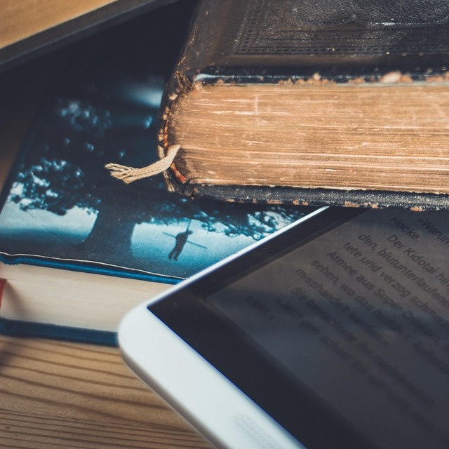 stack of books with tablet